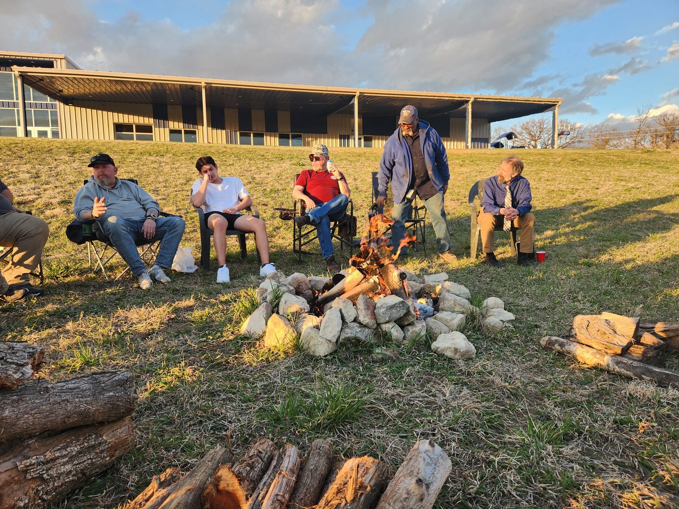 CV Men gathered around a fire